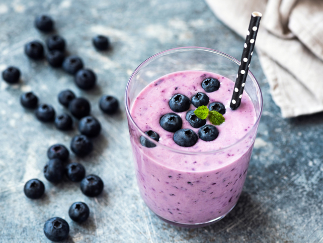 Tasty blueberry smoothie in glass